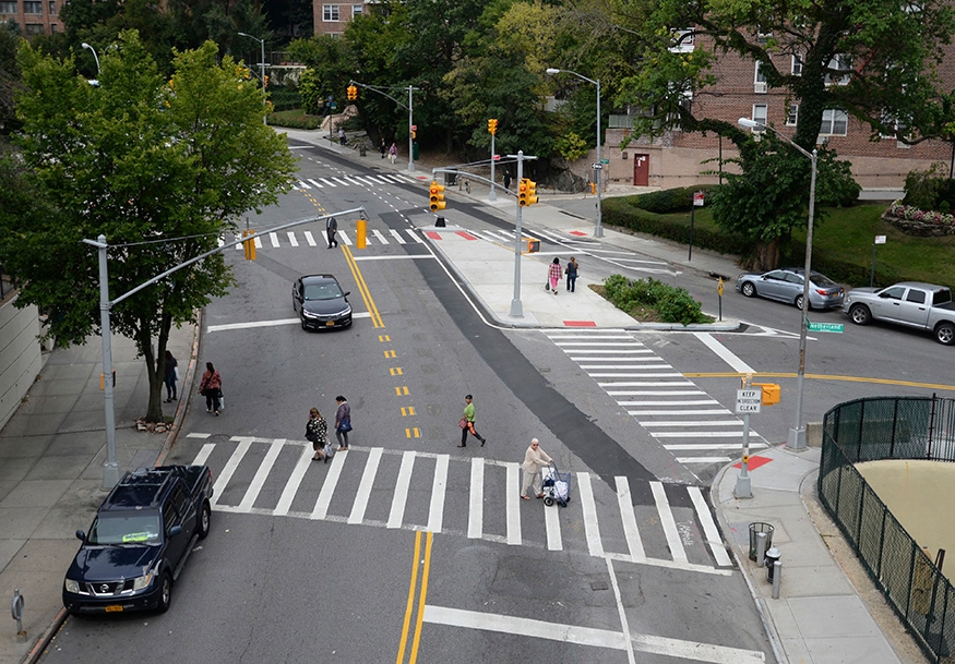 Aerial view of pedestrians crossing triangular intersection