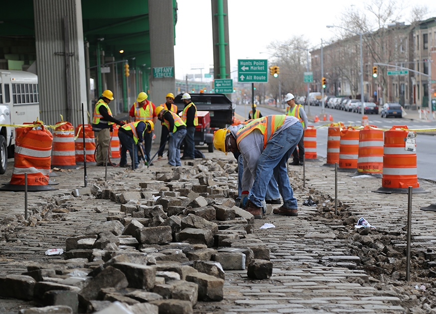 Workers replacing cobblestone